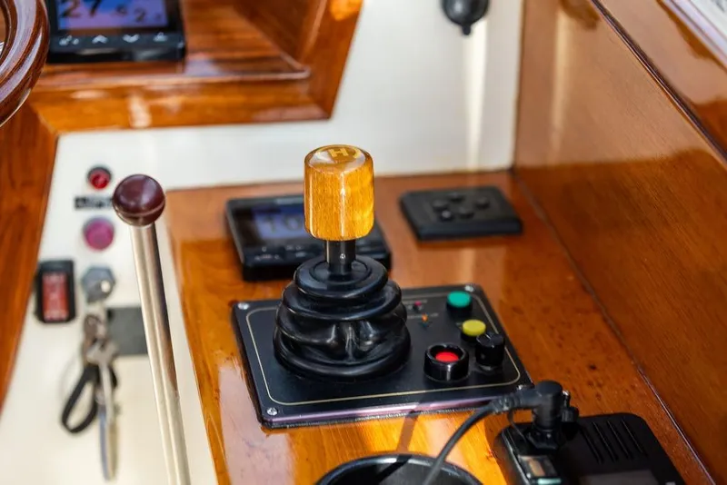 Slide: The Image of Control panel of a 2002 Hinckley Picnic Boat 36 EP with joystick and buttons. - 13