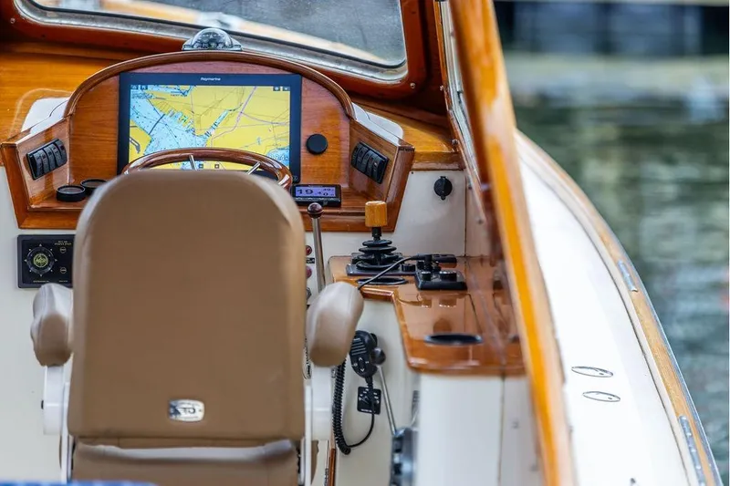 Slide: The Image of Helm of 2002 Hinckley Picnic Boat 36 EP with navigation display and controls. - 14