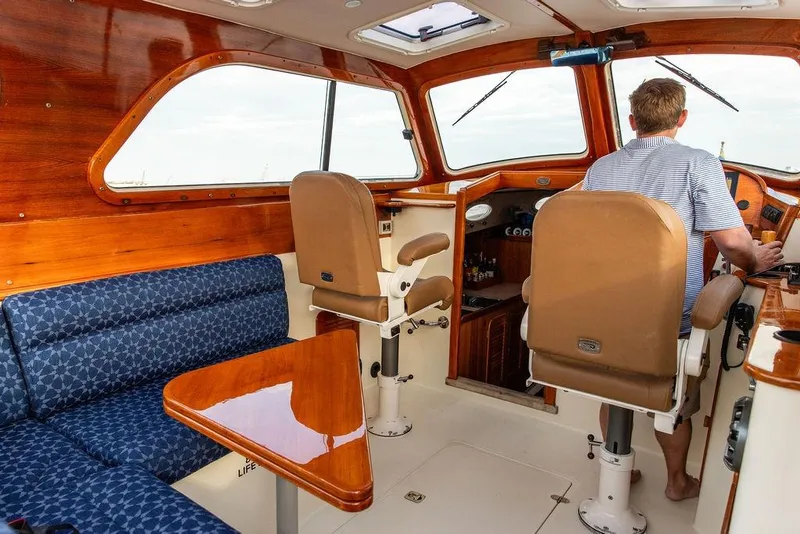 Slide: The Image of Interior of 2002 Hinckley Picnic Boat 36 EP with wood accents and seating. - 15