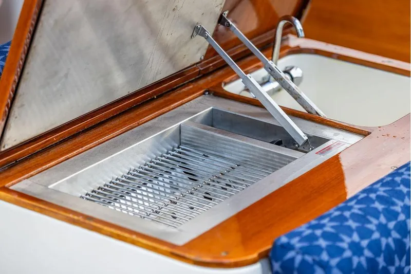 Slide: The Image of Open grill compartment on 2002 Hinckley Picnic Boat 36 EP with wooden trim. - 20