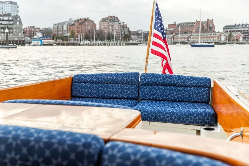 Slide: The Image of Hinckley Picnic Boat 36 EP, 2002, with American flag, docked near urban waterfront. - 23