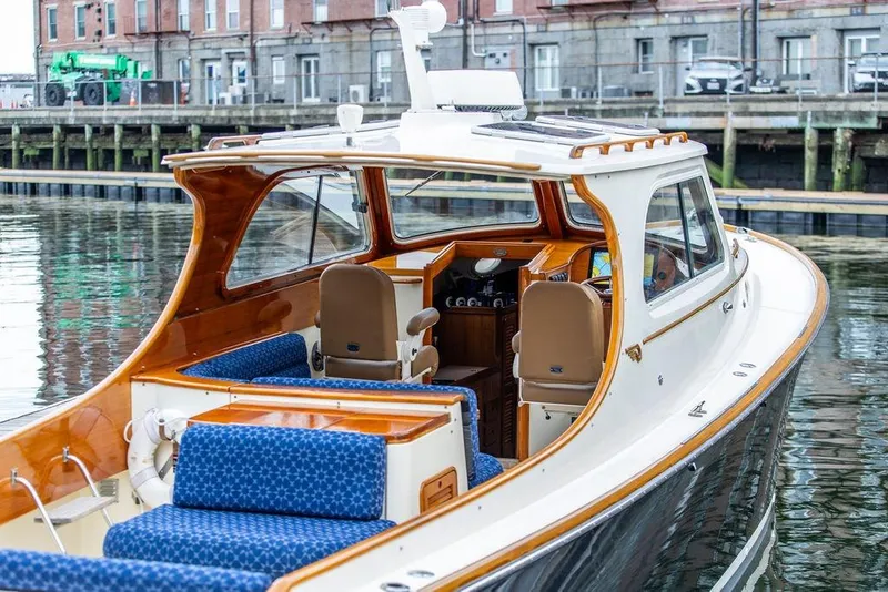 Slide: The Image of 2002 Hinckley Picnic Boat 36 EP docked, showcasing elegant design and luxurious seating. - 25