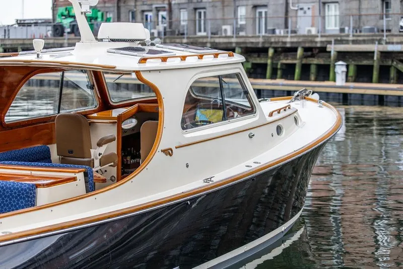 Slide: The Image of 2002 Hinckley Picnic Boat 36 EP docked, showcasing elegant design and classic craftsmanship. - 26