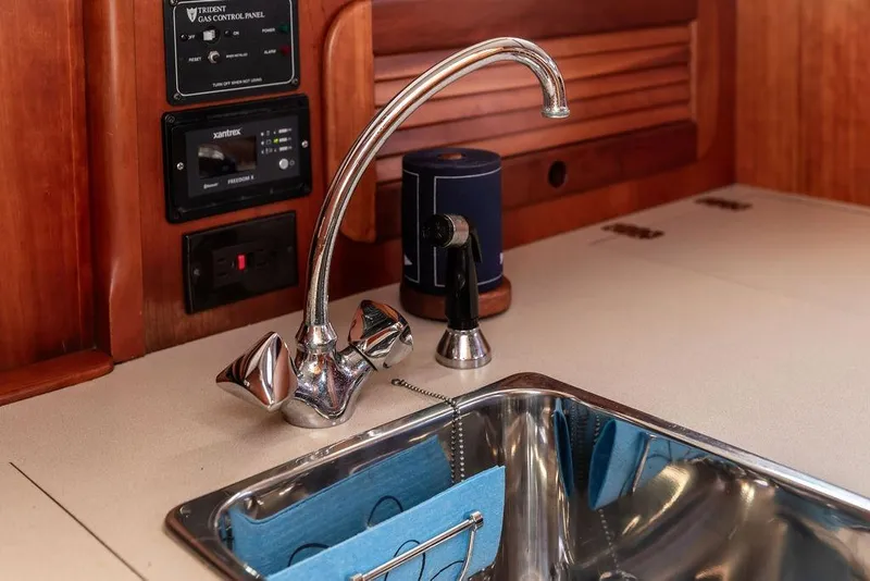 Slide: The Image of Hinckley Picnic Boat 36 EP 2002 kitchen sink with chrome faucet and control panel. - 31