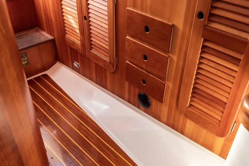 Slide: The Image of Interior of 2002 Hinckley Picnic Boat 36 EP with wooden cabinetry and flooring. - 36