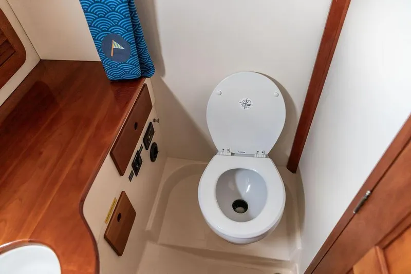 Slide: The Image of Hinckley Picnic Boat 36 EP 2002 bathroom with wooden accents and toilet. - 39