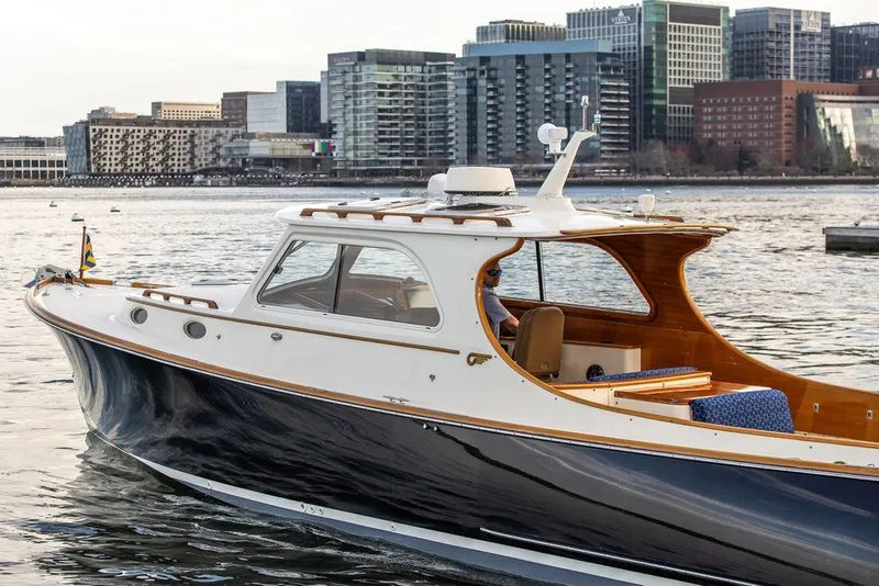 Slide: The Image of 2002 Hinckley Picnic Boat 36 EP cruising near urban waterfront skyline. - 4