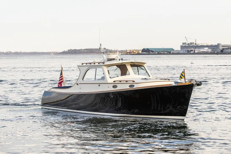Slide: The Image of 2002 Hinckley Picnic Boat 36 EP cruising on calm waters. - 44