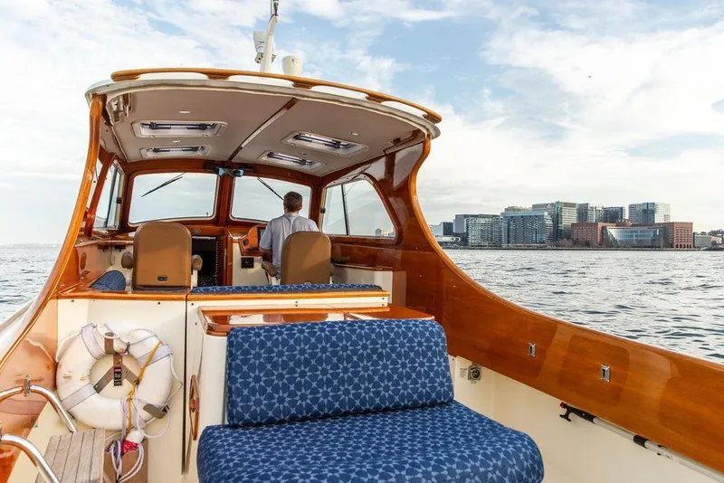 Slide: The Image of 2002 Hinckley Picnic Boat 36 EP cruising near city skyline on a sunny day. - 7