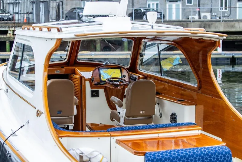 Slide: The Image of 2002 Hinckley Picnic Boat 36 EP interior with wooden finish and navigation system. - 8