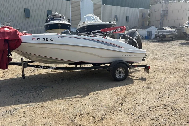 Slide: The Image of 2022 Tahoe T16 boat on trailer in a boatyard setting. - 1