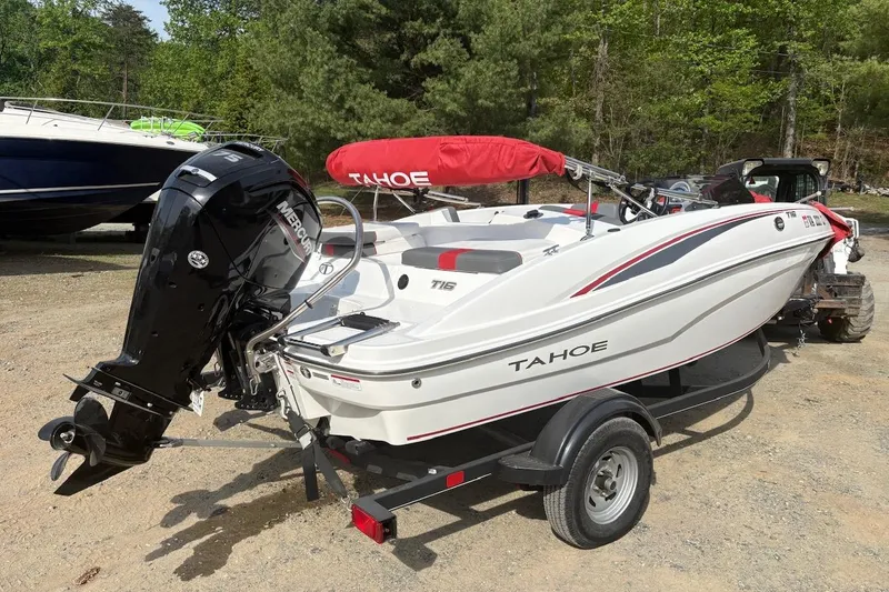 Slide: The Image of 2022 Tahoe T16 boat with Mercury engine on trailer, parked outdoors. - 3