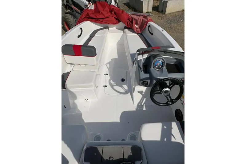 Slide: The Image of 2022 Tahoe T16 boat interior with steering wheel and seating, featuring red and gray accents. - 6