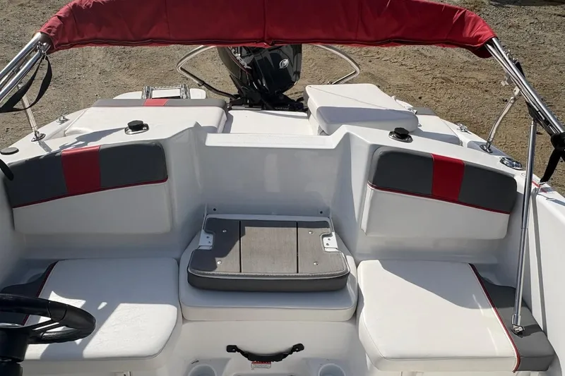 Slide: The Image of 2022 Tahoe T16 boat interior with red and gray seating, and a motor at the rear. - 8