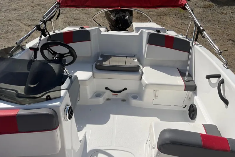 Slide: The Image of 2022 Tahoe T16 boat interior with red and gray seating, steering wheel, and windshield. - 9