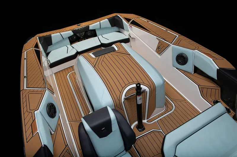 Slide: The Image of Manufacturer Provided Image: 2024 Nautique Ski boat interior with teak flooring and light blue seating. - 15