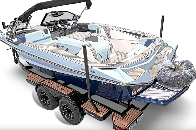 Slide: The Image of 2024 Nautique Ski Nautique boat on trailer, featuring sleek design and modern interior. - 2