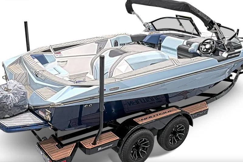 Slide: The Image of 2024 Nautique Ski Nautique boat on trailer, featuring sleek design and modern interior. - 3