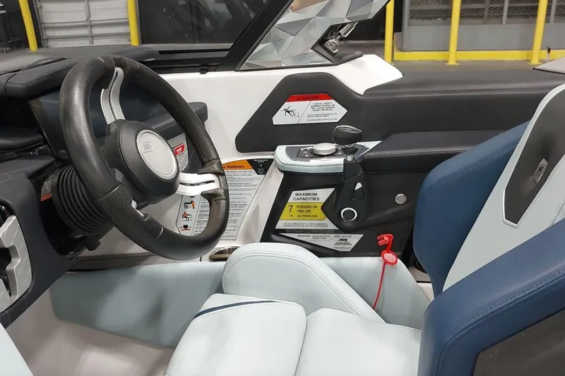 Slide: The Image of 2024 Nautique Ski Nautique boat interior with steering wheel and control panel. - 4
