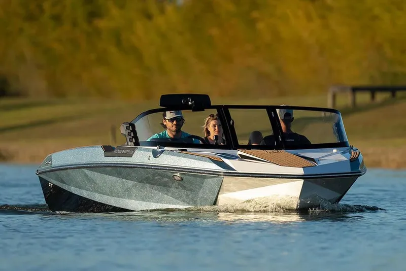 Slide: The Image of Manufacturer Provided Image: 2024 Nautique Ski boat cruising on a lake with passengers. - 7