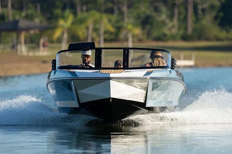 Slide: The Image of Manufacturer Provided Image: 2024 Nautique Ski boat cruising on a lake with passengers. - 8