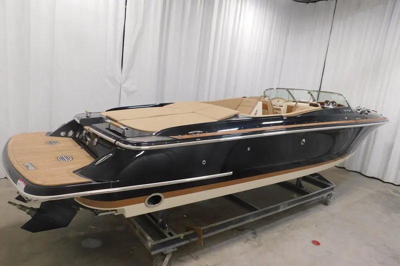 Slide: The Image of 2022 Chris-Craft Corsair 34 boat with sleek black exterior and luxurious interior. - 11