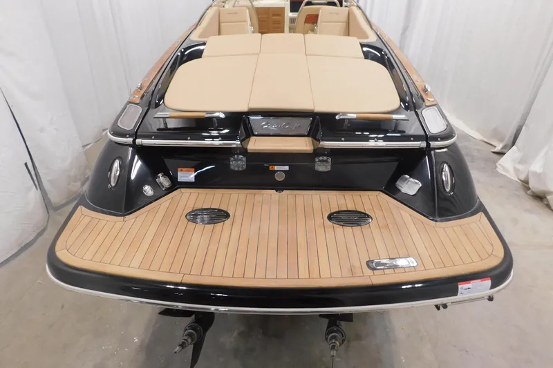 Slide: The Image of 2022 Chris-Craft Corsair 34 boat, rear view, featuring elegant teak decking and luxurious seating. - 13