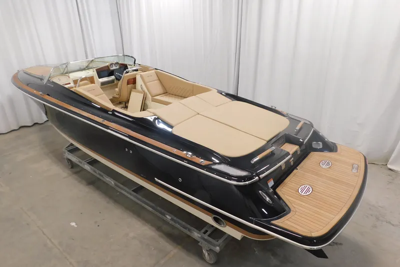 Slide: The Image of 2022 Chris-Craft Corsair 34 luxury boat with elegant tan interior and sleek black exterior. - 16