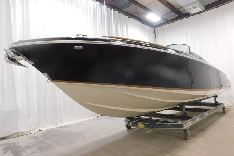 Slide: The Image of 2022 Chris-Craft Corsair 34 boat displayed indoors on a trailer. - 17