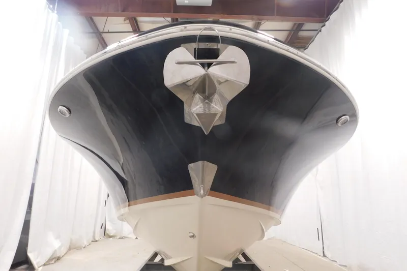 Slide: The Image of 2022 Chris-Craft Corsair 34 boat in a showroom, showcasing sleek hull design. - 18