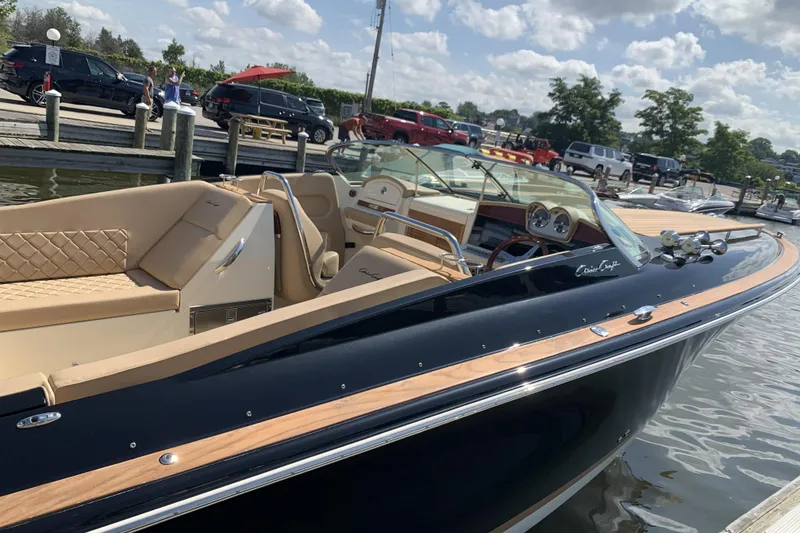 Slide: The Image of 2022 Chris-Craft Corsair 34 luxury boat docked, featuring elegant design and plush seating. - 2