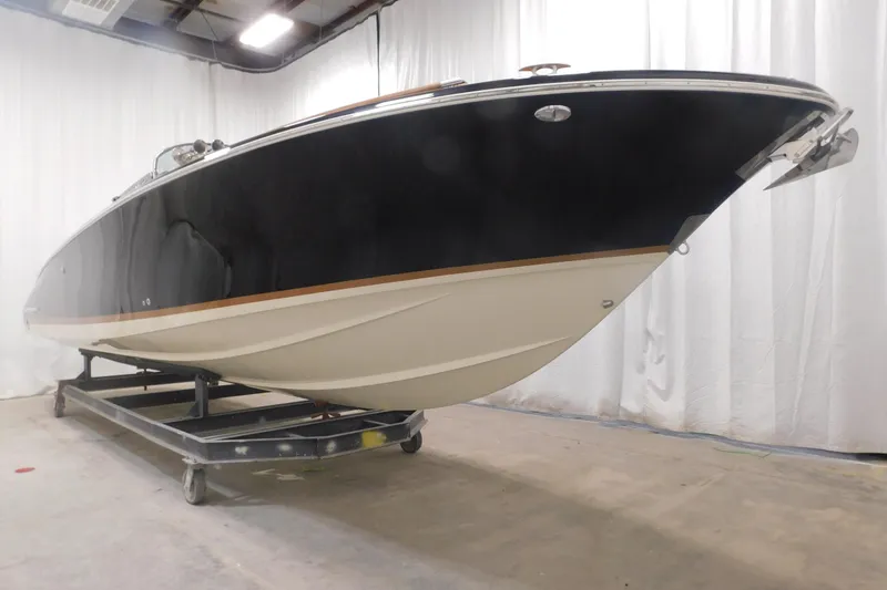 Slide: The Image of 2022 Chris-Craft Corsair 34 boat displayed indoors on a trailer. - 22