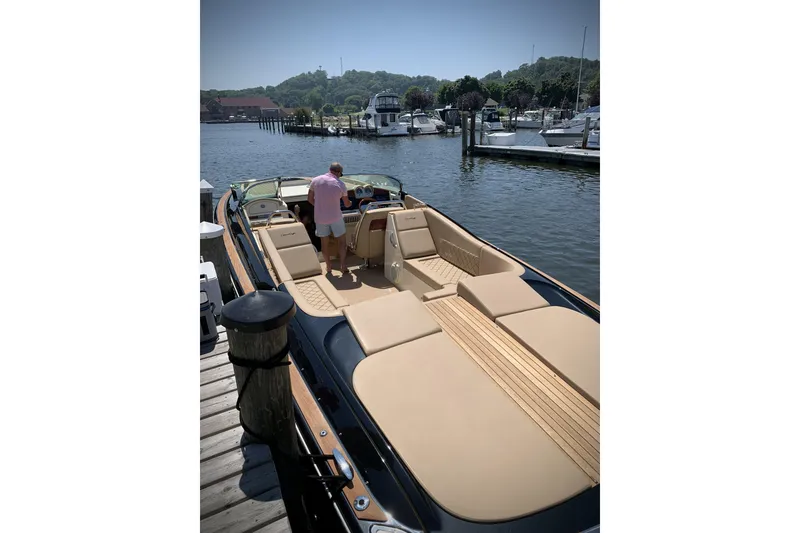 Slide: The Image of 2022 Chris-Craft Corsair 34 docked at marina, featuring luxurious seating and sleek design. - 3