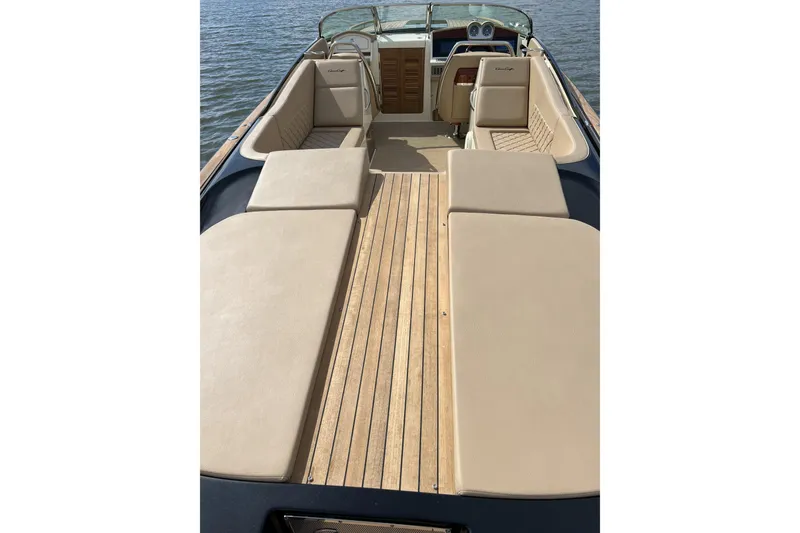 Slide: The Image of 2022 Chris-Craft Corsair 34 boat with luxurious seating and wooden deck on water. - 5