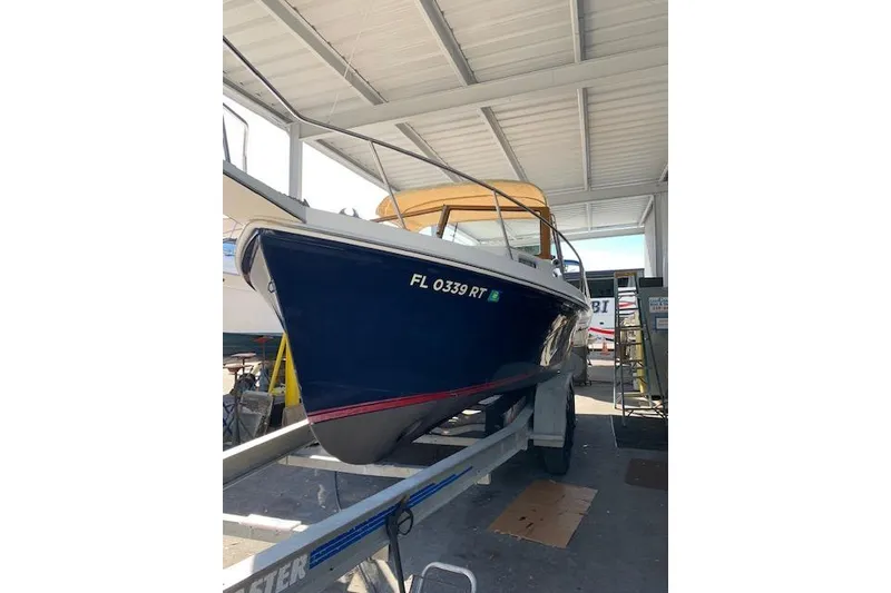 The Image of 1999 Nauset Downeast Cruiser on trailer in covered storage. - 1
