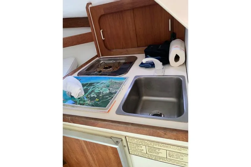 Slide: The Image of 1999 Nauset Downeast Cruiser galley with sink, stove, and map on counter. - 10