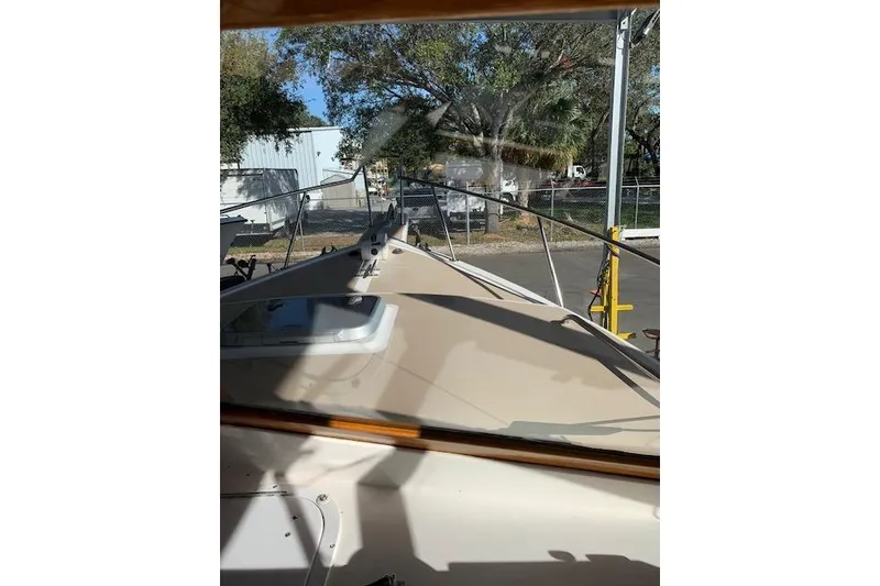 Slide: The Image of 1999 Nauset Downeast Cruiser boat deck view with trees and buildings in background. - 12