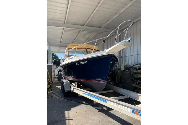 Slide: The Image of 1999 Nauset Downeast Cruiser on trailer in covered storage area. - 3