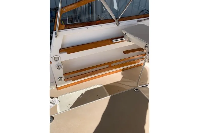 Slide: The Image of 1999 Nauset Downeast Cruiser interior with wood accents and foldable table. - 8