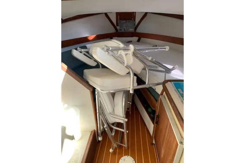 Slide: The Image of Interior of 1999 Nauset Downeast Cruiser with stacked folding chairs. - 9