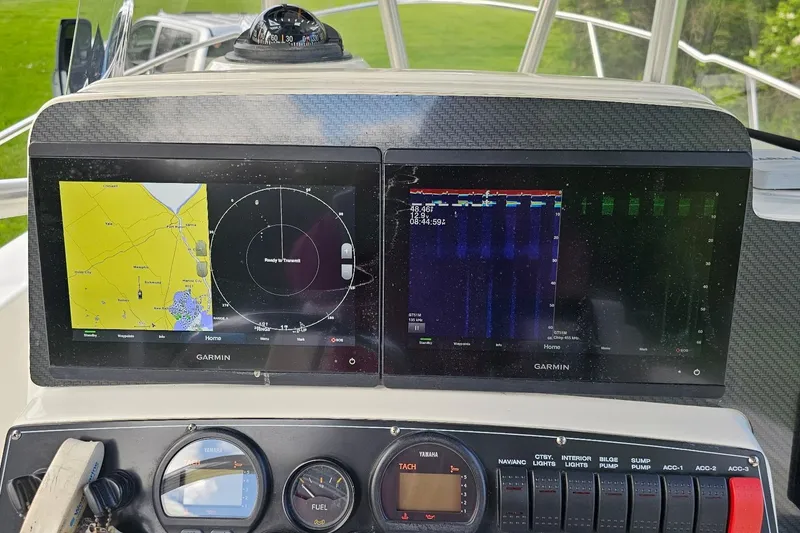 Slide: The Image of Dashboard of a 1999 Boston Whaler 23 Outrage with Garmin navigation displays. - 10