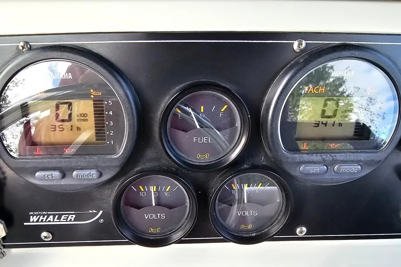 Slide: The Image of Instrument panel of a 1999 Boston Whaler 23 Outrage boat, featuring Yamaha gauges. - 11