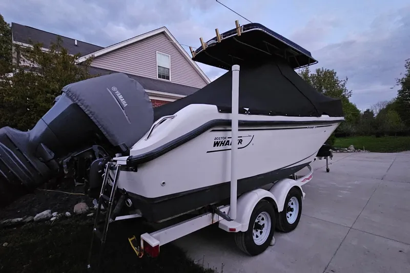 Slide: The Image of 1999 Boston Whaler 23 Outrage boat on trailer with Yamaha engine, parked in driveway. - 16
