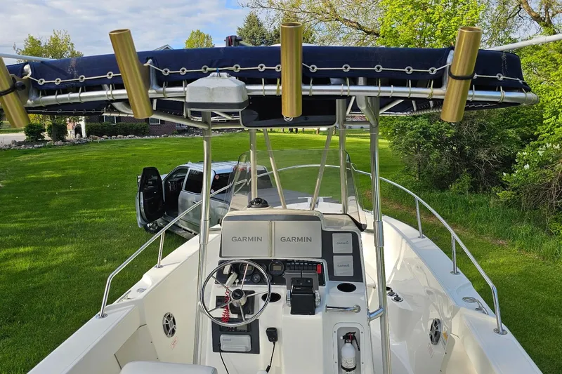 Slide: The Image of 1999 Boston Whaler 23 Outrage boat with Garmin electronics, parked on grassy area. - 4