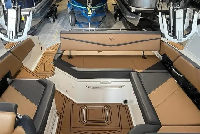 Slide: The Image of 2023 Cobalt R6 Surf boat interior with luxurious tan and black seating. - 10
