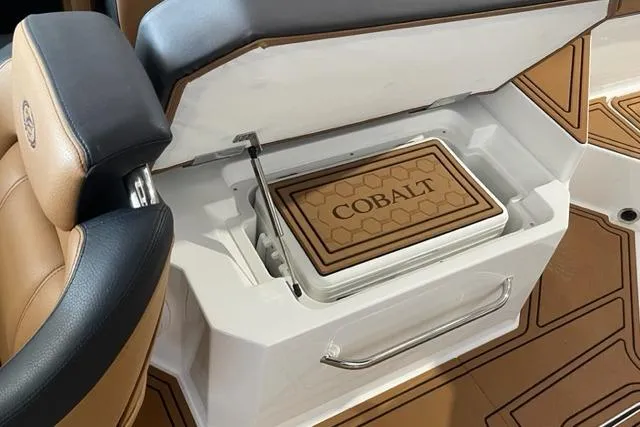 Slide: The Image of 2023 Cobalt R6 Surf boat interior with built-in cooler and stylish seating. - 12