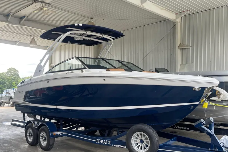 Slide: The Image of 2023 Cobalt R6 Surf boat in a showroom, featuring sleek design and modern features. - 17