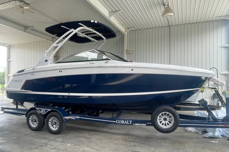 Slide: The Image of 2023 Cobalt R6 Surf boat on trailer in covered storage area. - 19