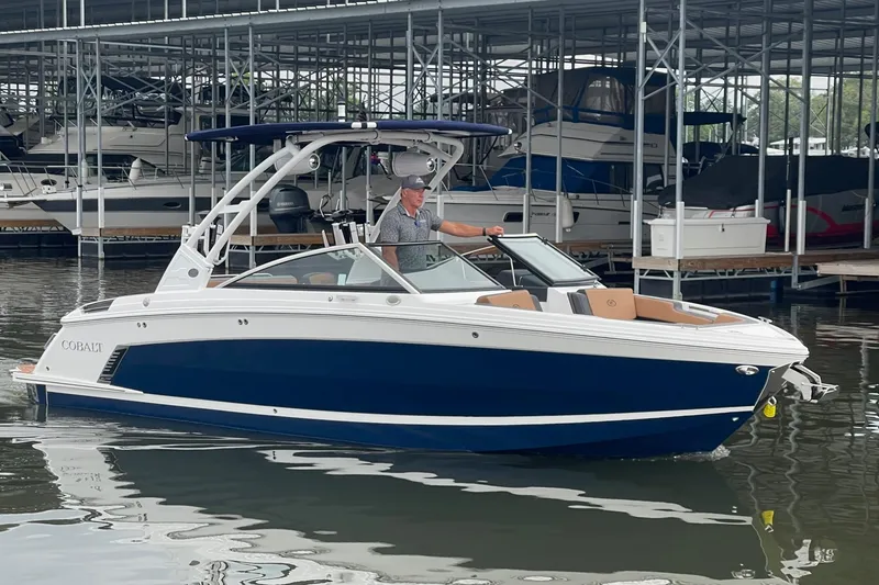 Slide: The Image of 2023 Cobalt R6 Surf boat docked in marina, featuring sleek design and modern features. - 22