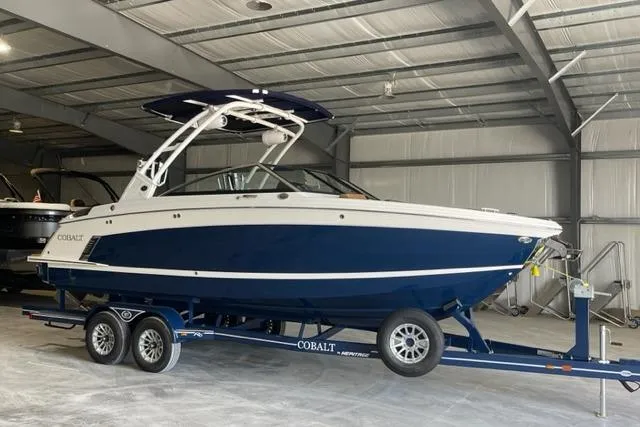 Slide: The Image of 2023 Cobalt R6 Surf boat in a warehouse on a trailer. - 3